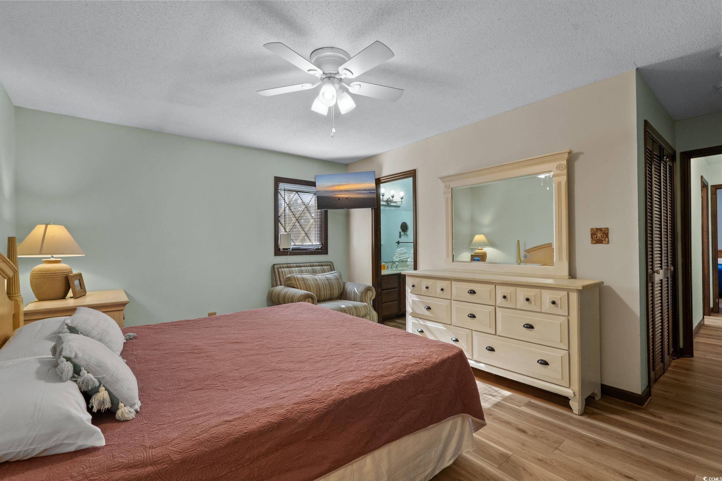 1063 Burcale Road Myrtle Beach, SC 29579 - Photo 26 of 36 Bedroom featuring light wood-type flooring, a textured ceiling, and a ceiling fan