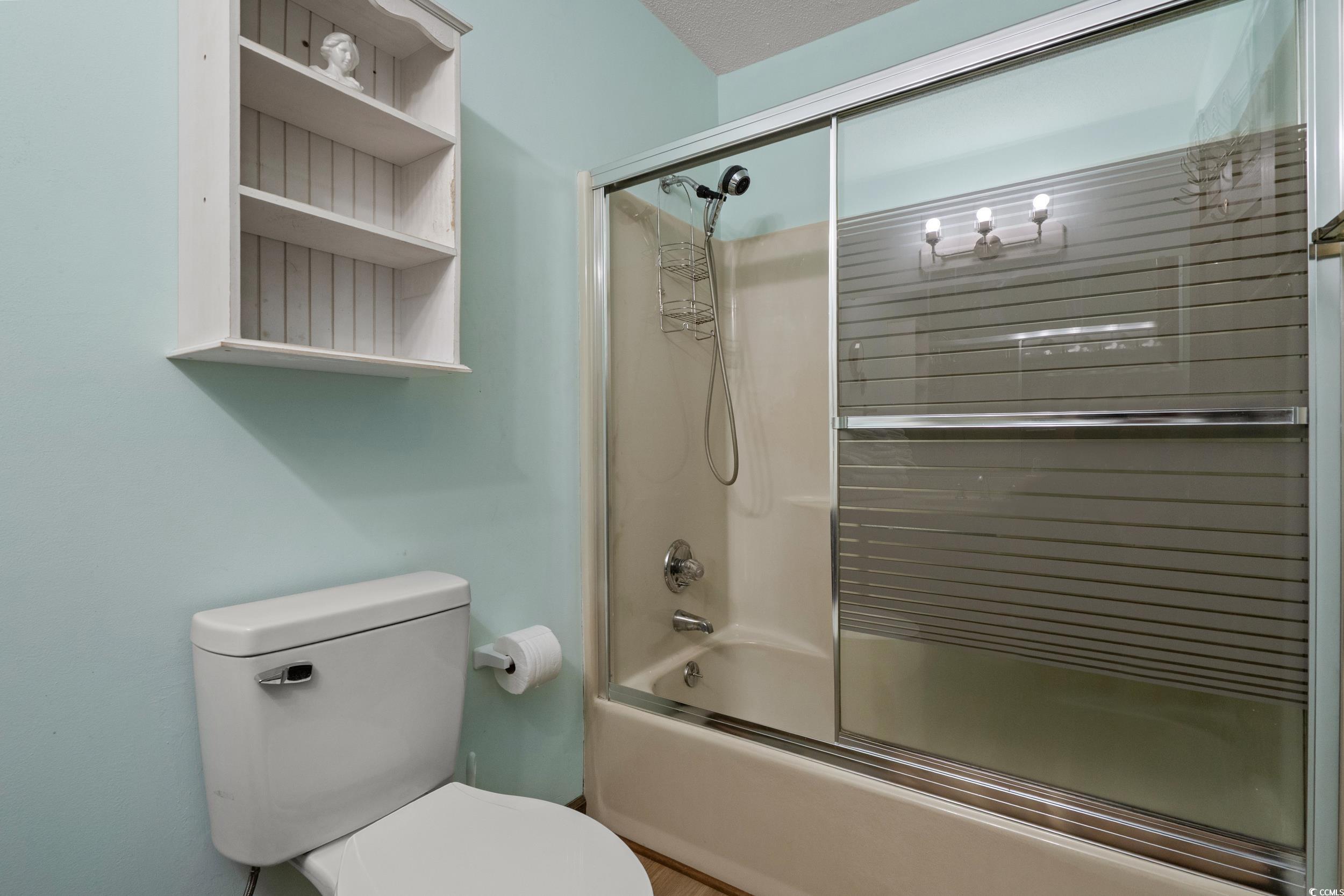 1063 Burcale Road Myrtle Beach, SC 29579 - Photo 28 of 36 Bathroom featuring combined bath / shower with glass door and toilet