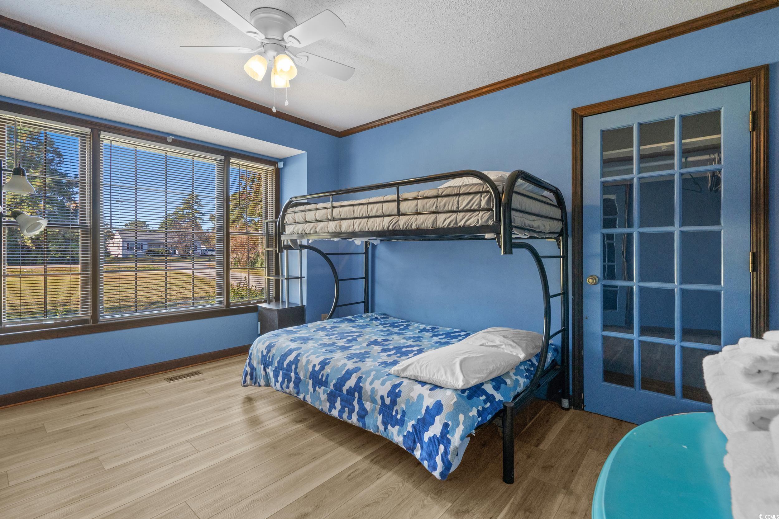 1063 Burcale Road Myrtle Beach, SC 29579 - Photo 31 of 36 Bedroom with crown molding, wood finished floors, a textured ceiling, and ceiling fan