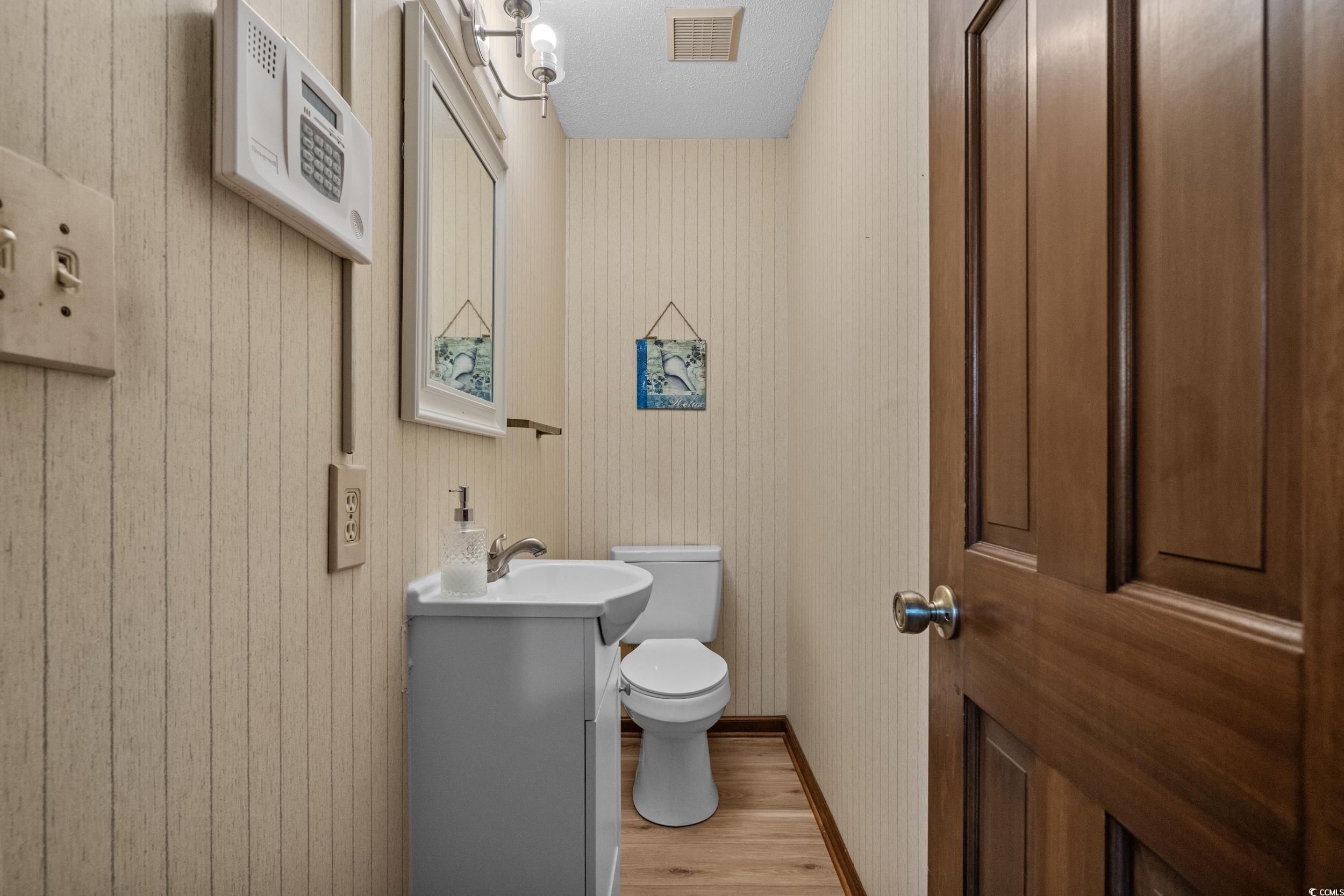 1063 Burcale Road Myrtle Beach, SC 29579 - Photo 35 of 36 Half bathroom featuring light wood finished floors and vanity