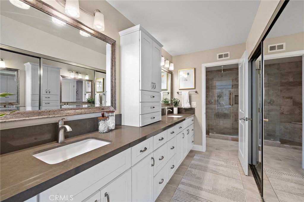 3326 Paseo Halcon San Clemente, CA 92672 - Photo 17 of 28 a bathroom with double vanity sinks a shower a mirror and a double vanity sink