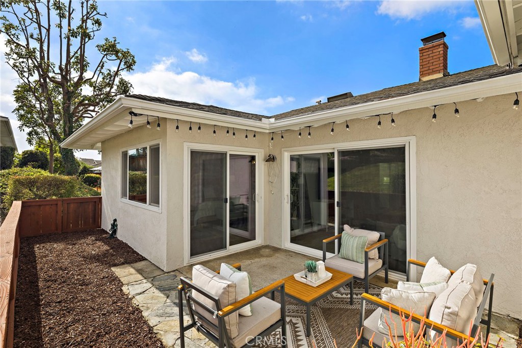 3326 Paseo Halcon San Clemente, CA 92672 - Photo 25 of 28 a view of a patio with table and chairs and wooden fence