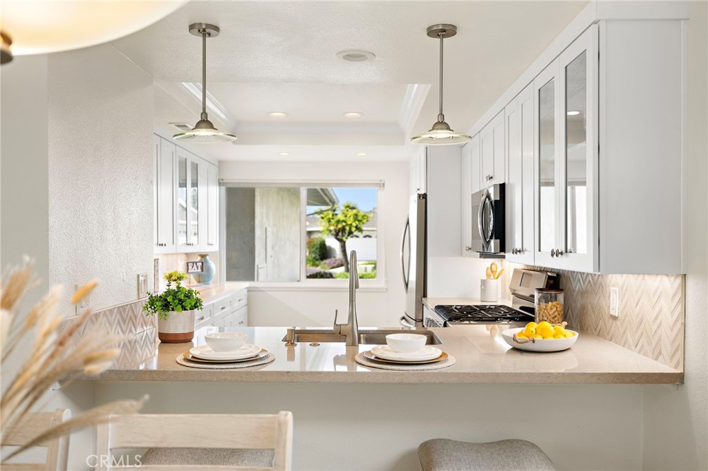 3326 Paseo Halcon San Clemente, CA 92672 - Photo 6 of 28 a kitchen with a sink and a chandelier