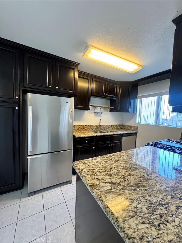 2255 Cahuilla Street, Unit 140 Colton, CA 92324 - Photo 2 of 9 a kitchen with kitchen island a counter top space cabinets and stainless steel appliances