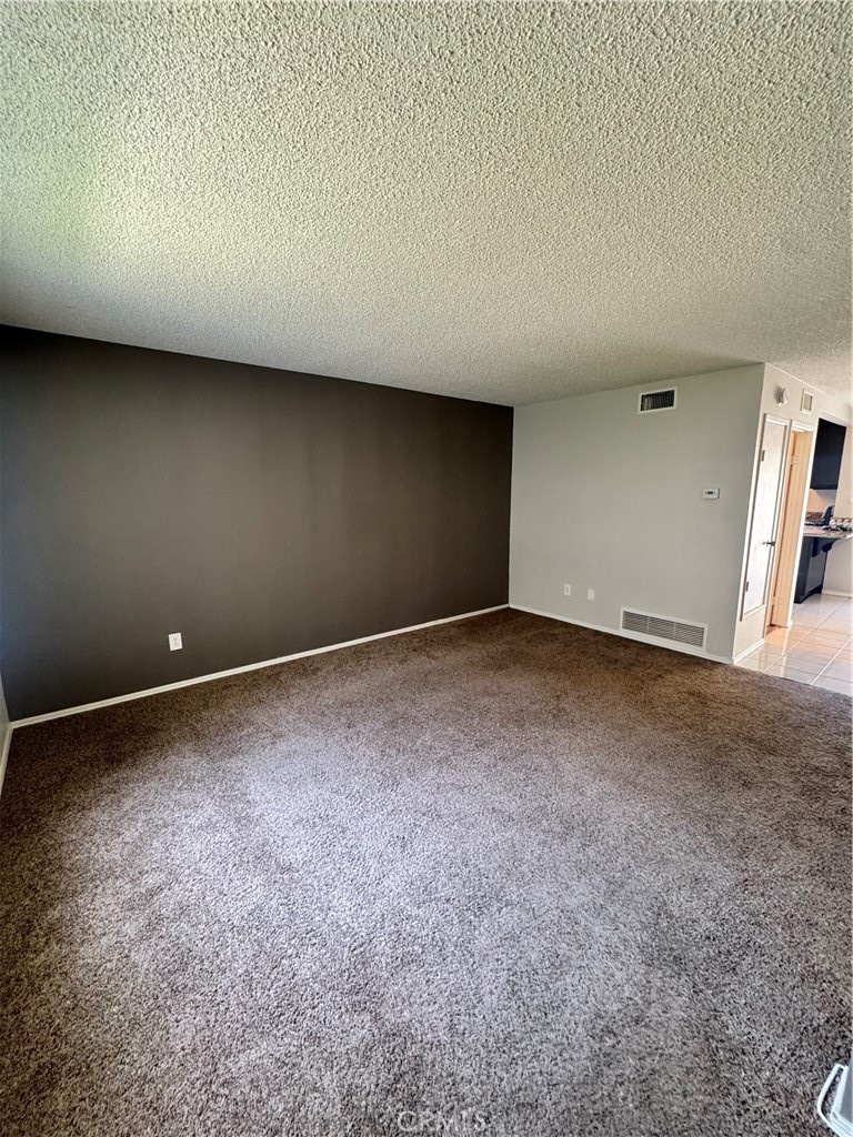 2255 Cahuilla Street, Unit 140 Colton, CA 92324 - Photo 5 of 9 a view of an empty room and entryway