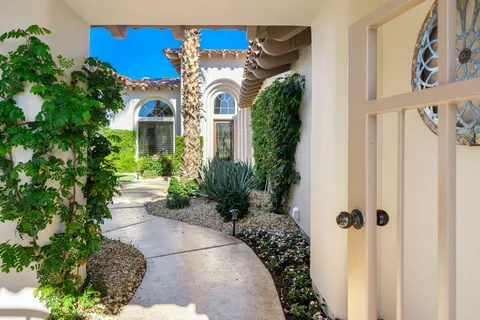 a view of a house with a flower garden