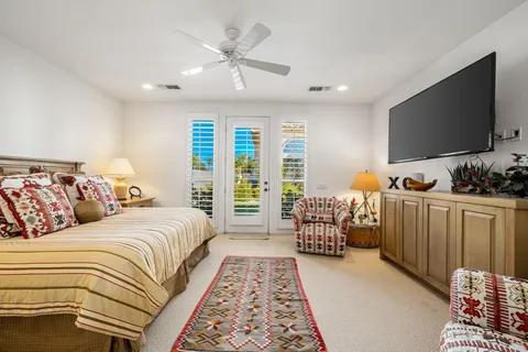 a bedroom with double bed and a flat screen tv