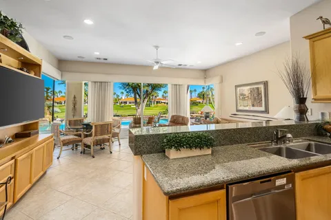 a kitchen with granite countertop a sink and a large window