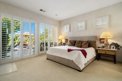a spacious bedroom with a bed and a large window