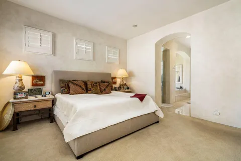 a bedroom with a bed and a lamp