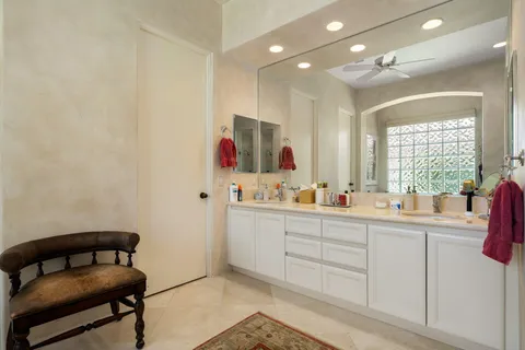 a bathroom with a sink mirror and a toilet