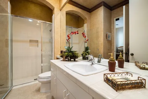 a bathroom with a sink vanity mirror and toilet