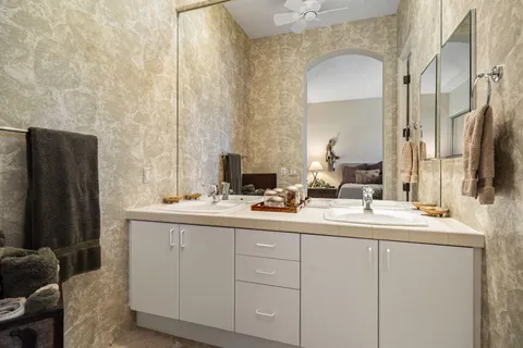 a bathroom with a double vanity sink and a mirror