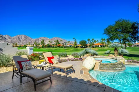 a view of swimming pool and outdoor seating