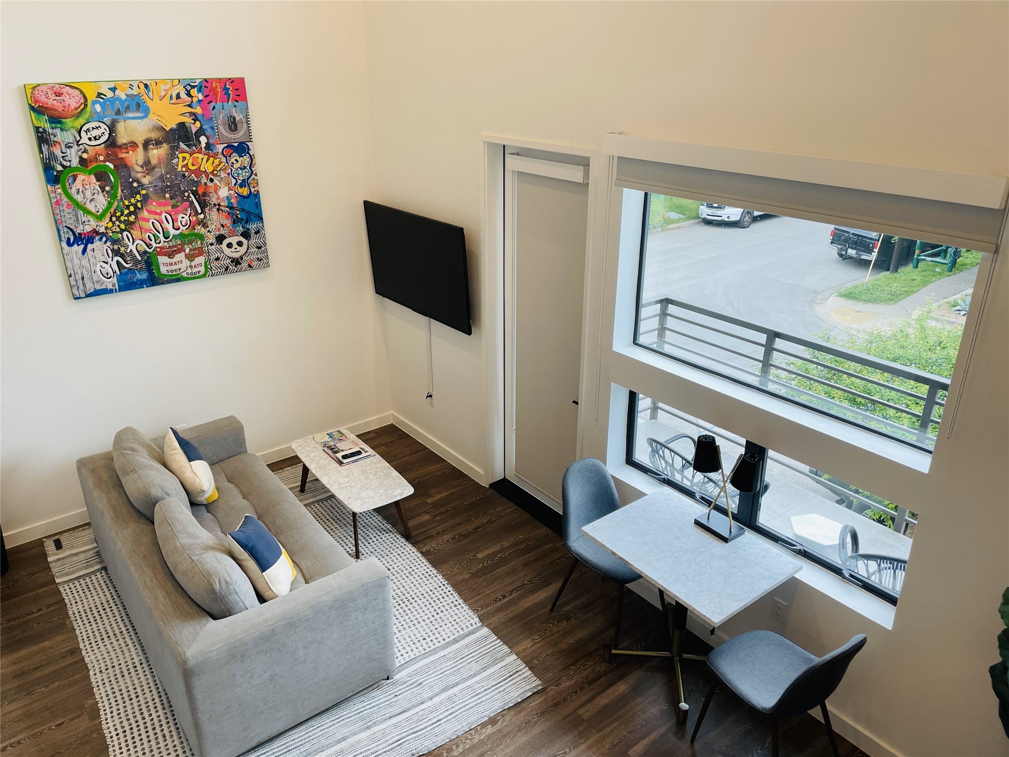 49 Navasota Street, Unit 201 Austin, TX 78702 - Photo 4 of 13 Living area featuring dark wood-style floors and a high ceiling