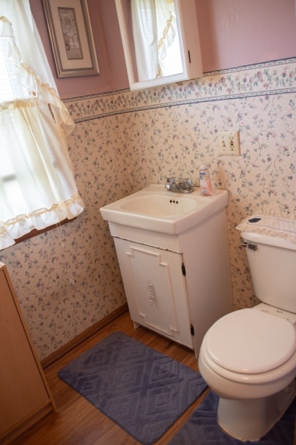 421 7th Avenue Erie, IL 61250 - Photo 15 of 27 a white toilet sitting next to a bathroom sink