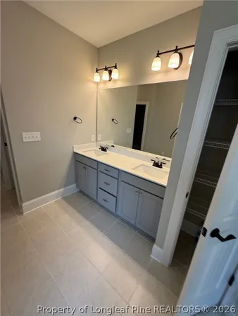 a bathroom with a double vanity sink and mirror