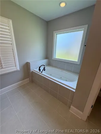 a bathroom with a tub and a window