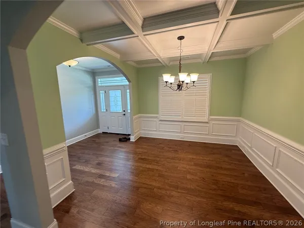 a view of a room with wooden floor and chandelier