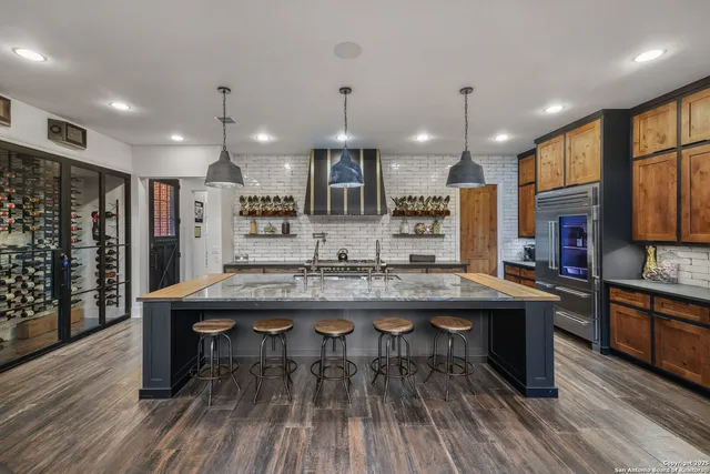 a large kitchen with cabinets table and chairs