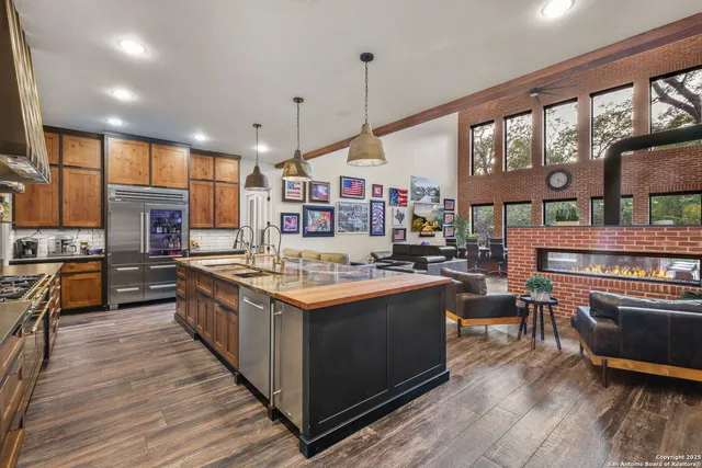 a kitchen with a stove and a wooden floor