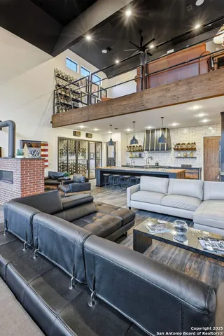 a living room with lots of furniture and chandelier
