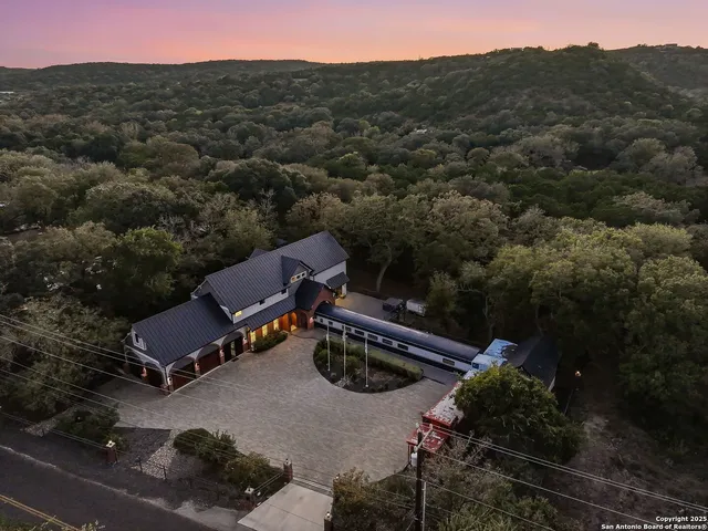 an aerial view of a house with a garden and a mountain view