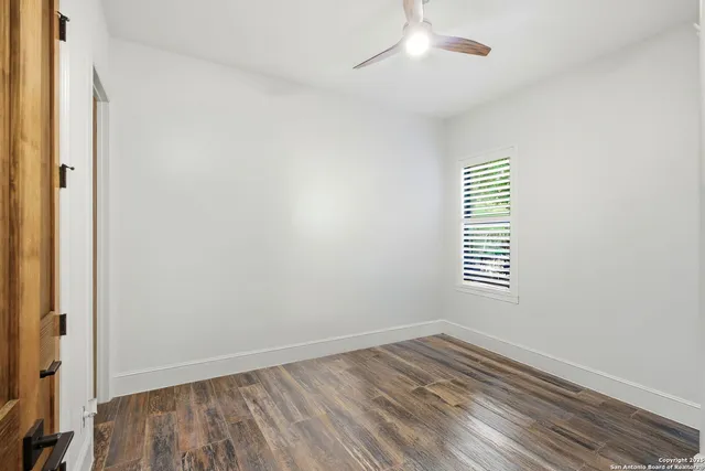 a bedroom with a large bed and a potted plant