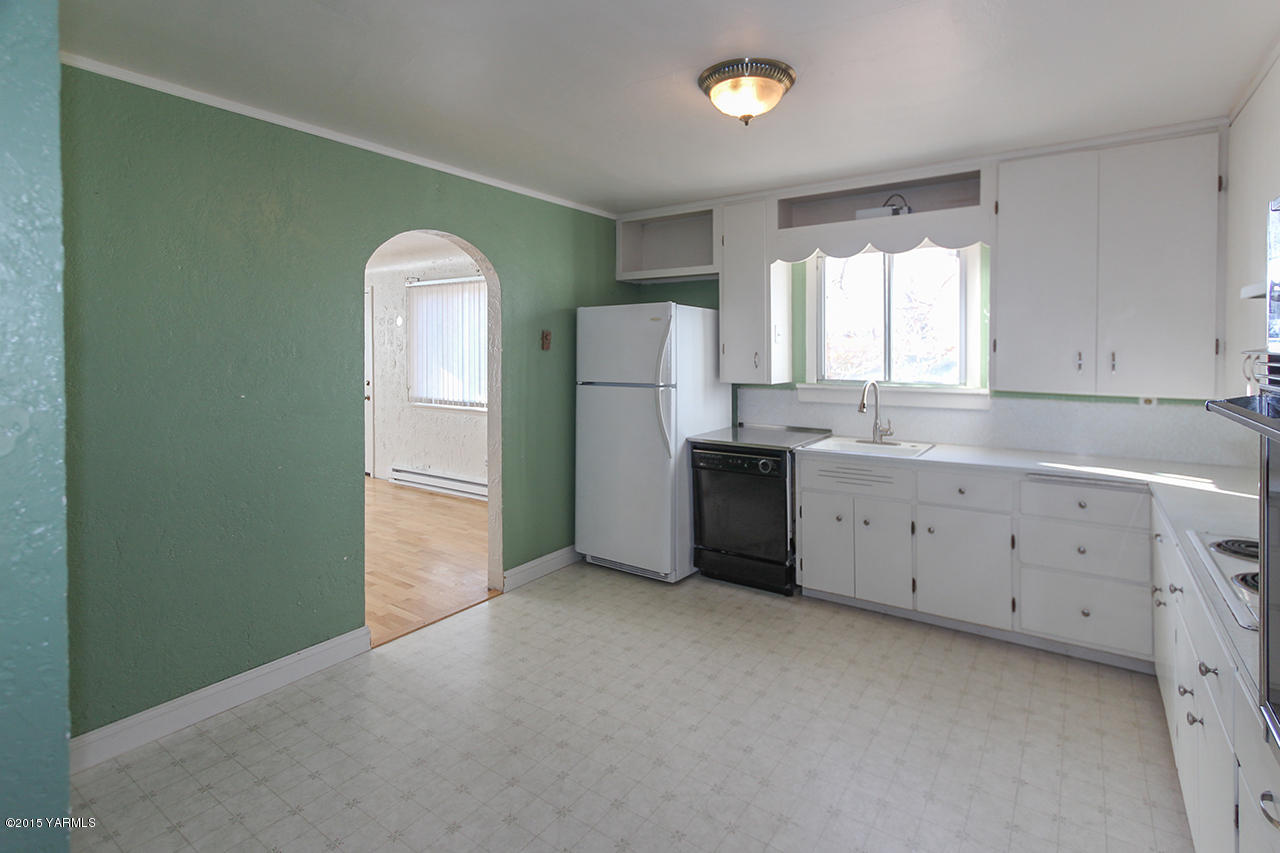 261 Wilcox Road Tieton, WA 98947 - Photo 3 of 15 a view of a kitchen with window and cabinet