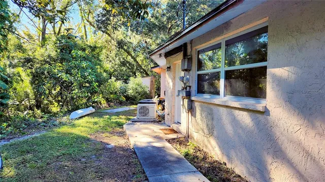 a view of a house with backyard and sitting area