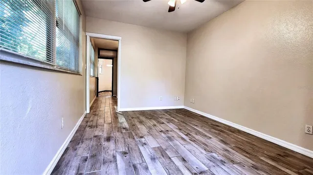 a view of a room with wooden floor and white walls