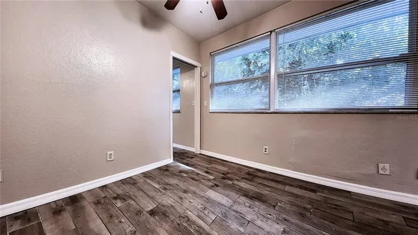 a view of room with window and wooden floor