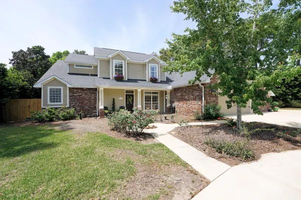 a front view of a house with yard and green space