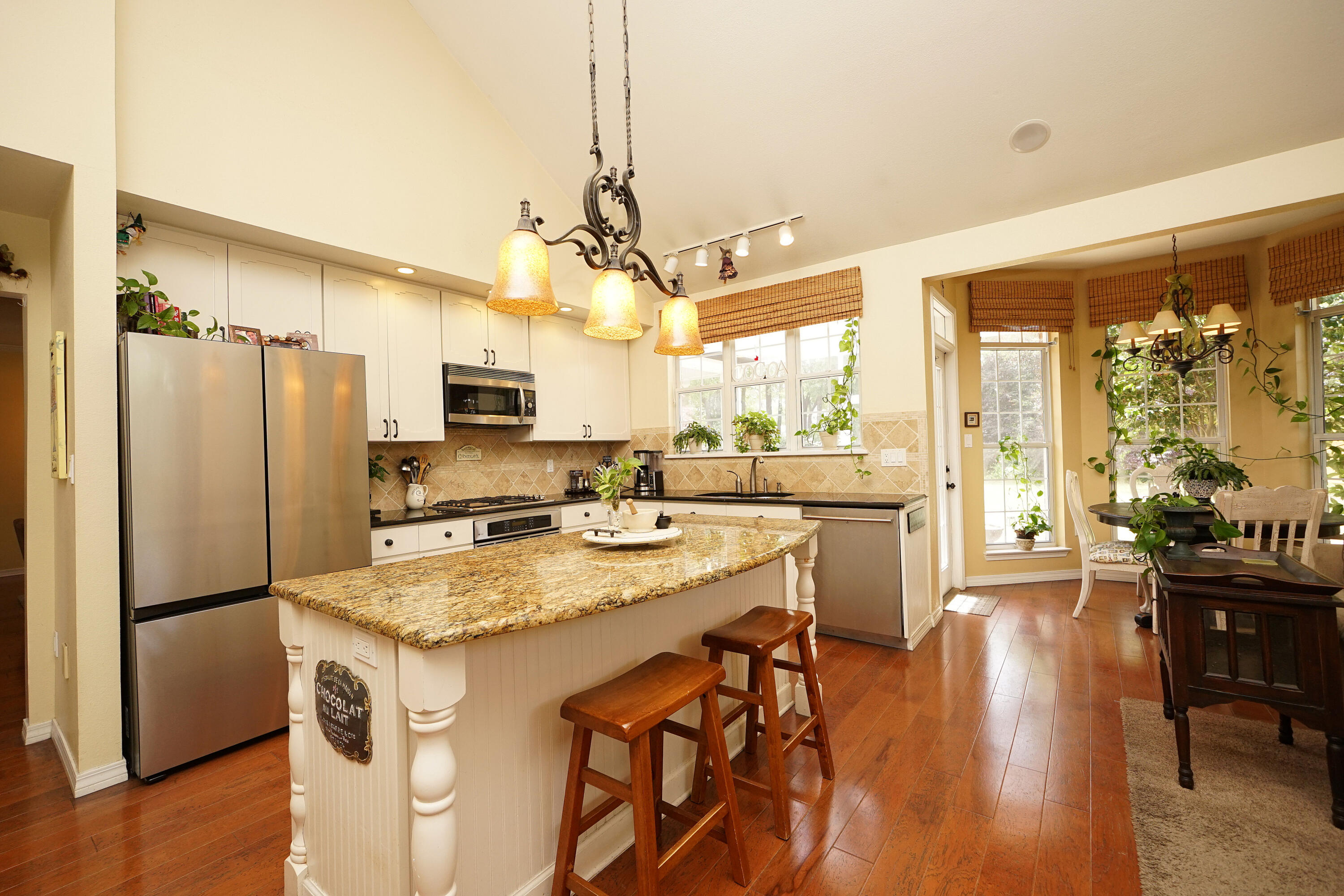 941 Ruckel Drive Niceville, FL 32578 - Photo 18 of 57 a kitchen with a refrigerator a sink a stove and chairs with wooden floor