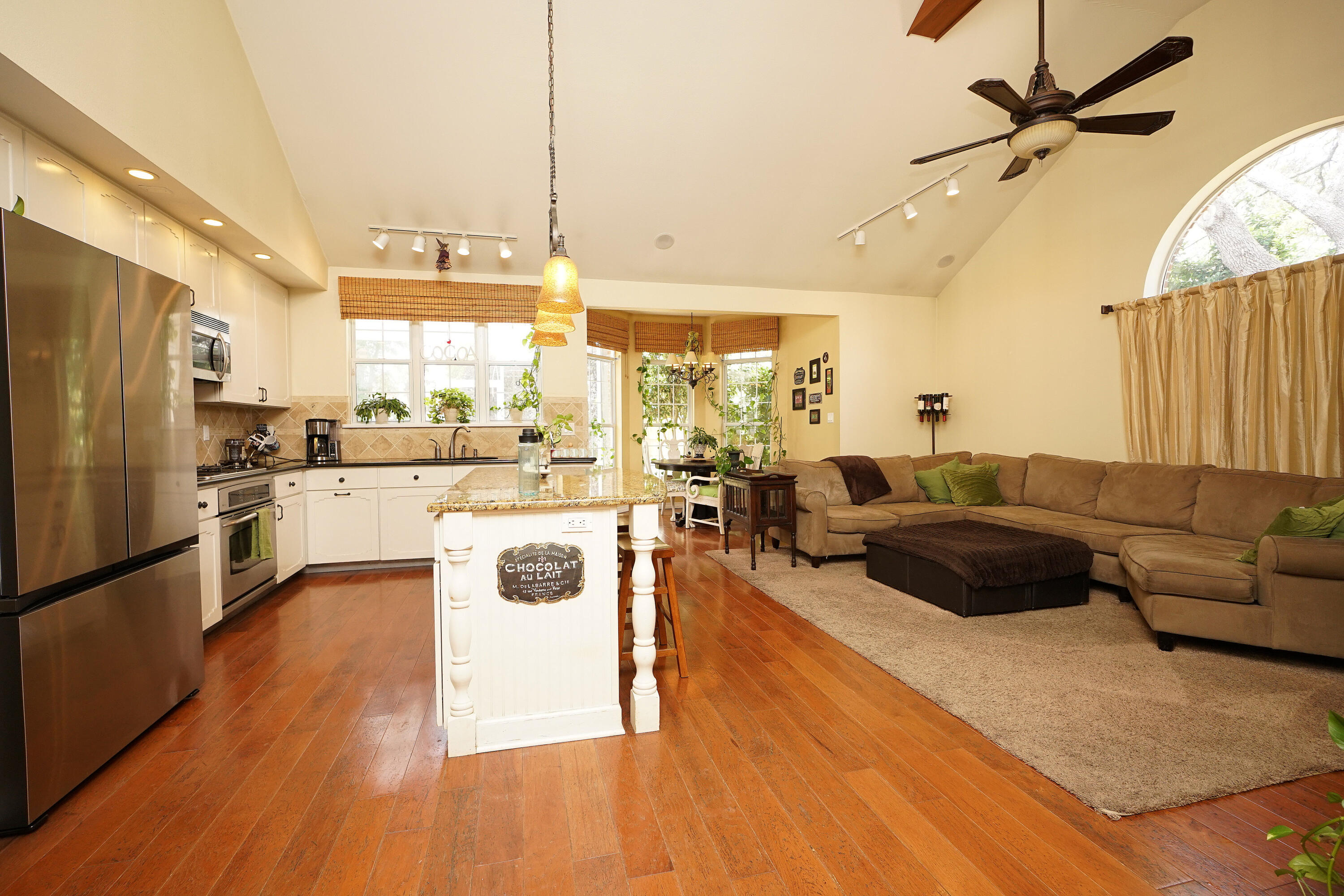 941 Ruckel Drive Niceville, FL 32578 - Photo 21 of 57 a large living room with stainless steel appliances granite countertop a stove a refrigerator a washer and dryer with wooden floor