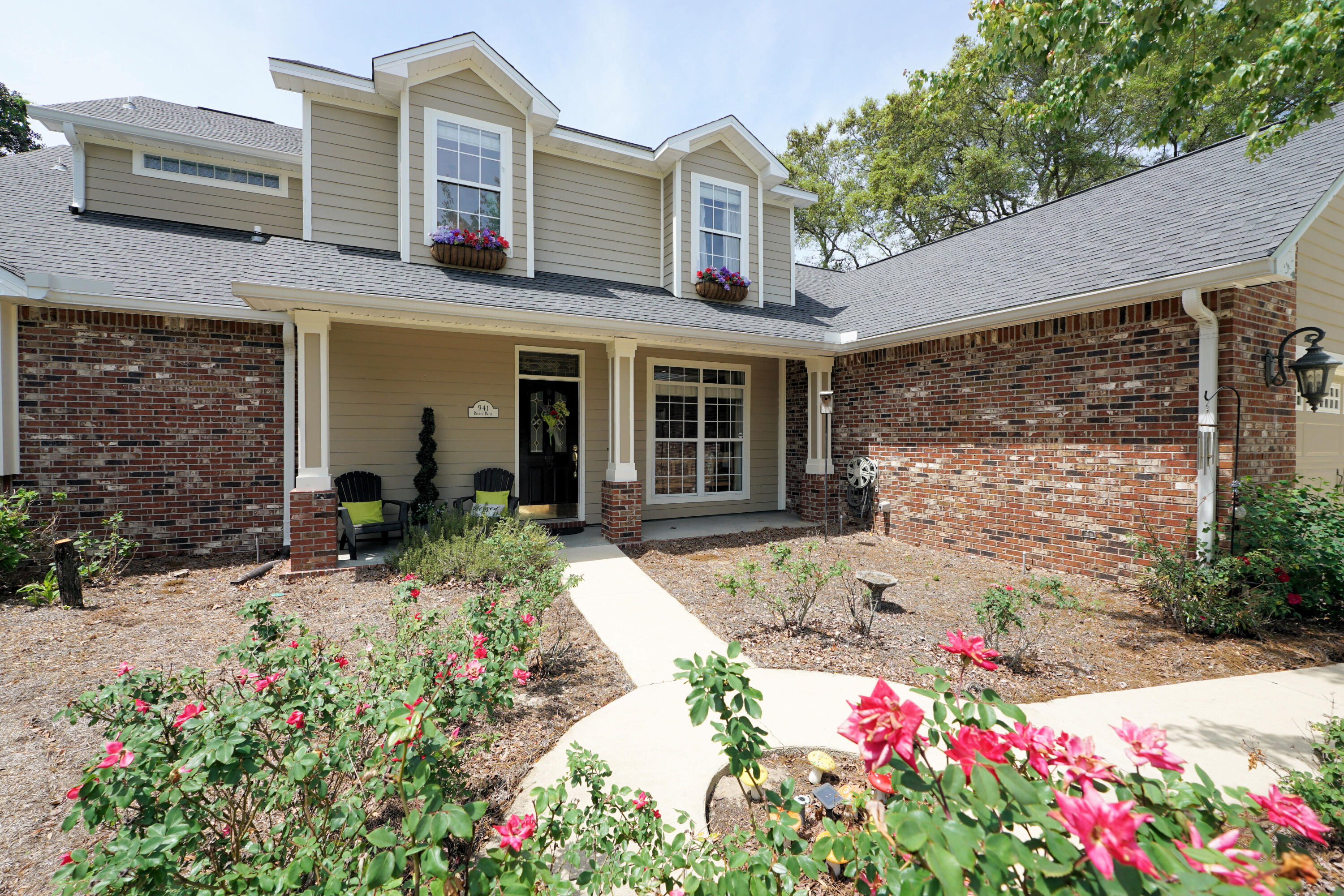 941 Ruckel Drive Niceville, FL 32578 - Photo 3 of 57 a front view of a house with a yard and fountain