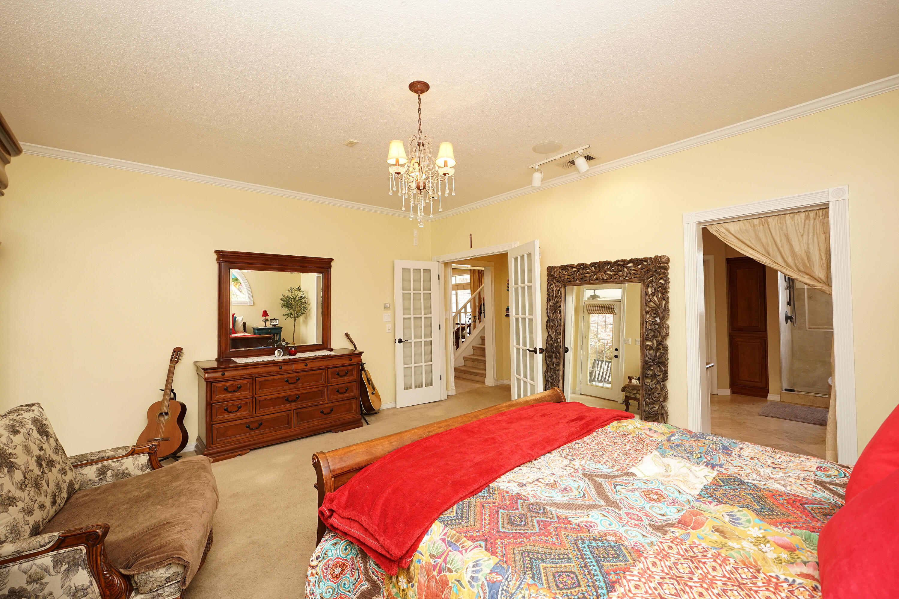 941 Ruckel Drive Niceville, FL 32578 - Photo 32 of 57 a spacious bedroom with a bed and dresser with mirror