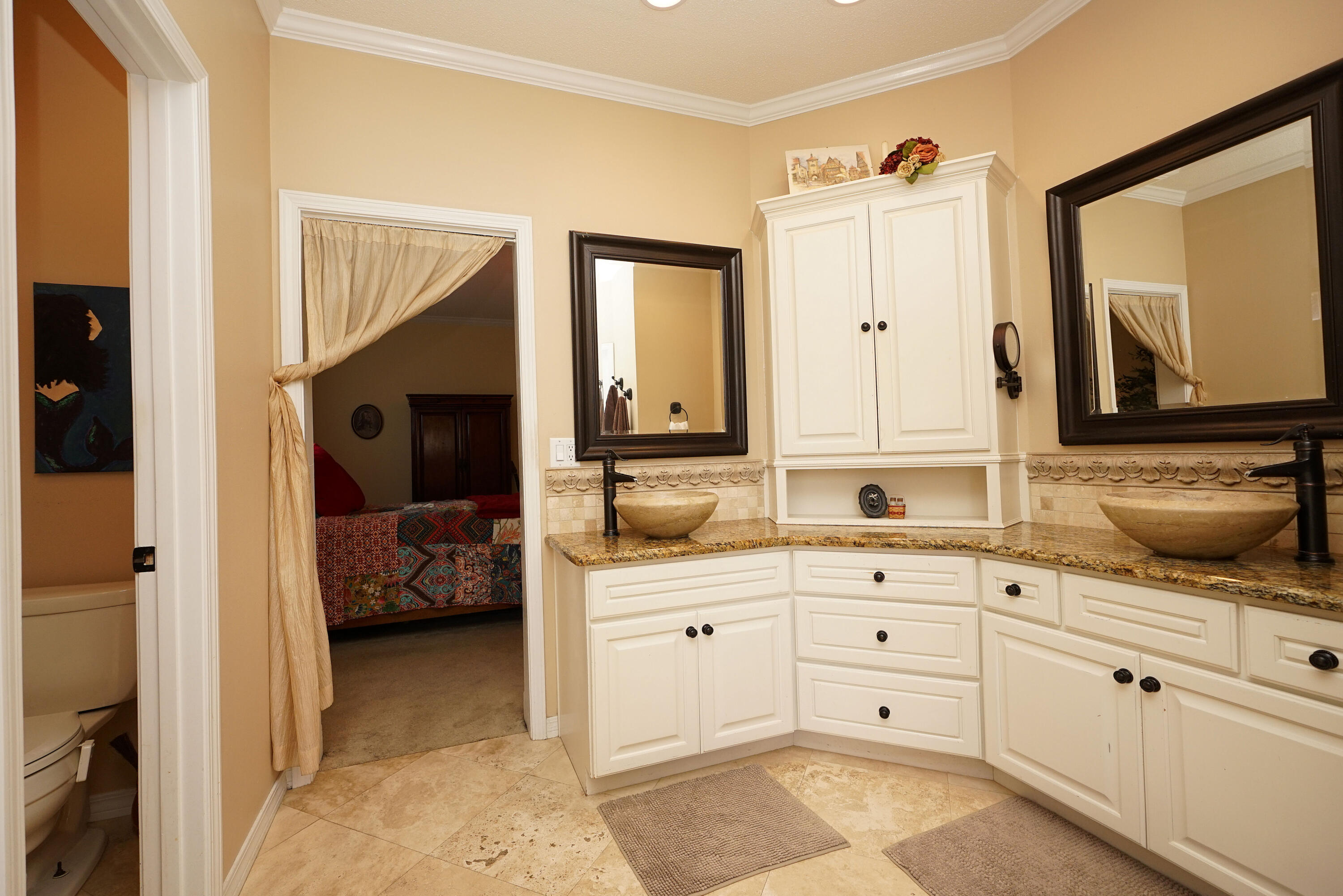 941 Ruckel Drive Niceville, FL 32578 - Photo 37 of 57 a en suite bathroom with a double vanity sink a mirror and shower