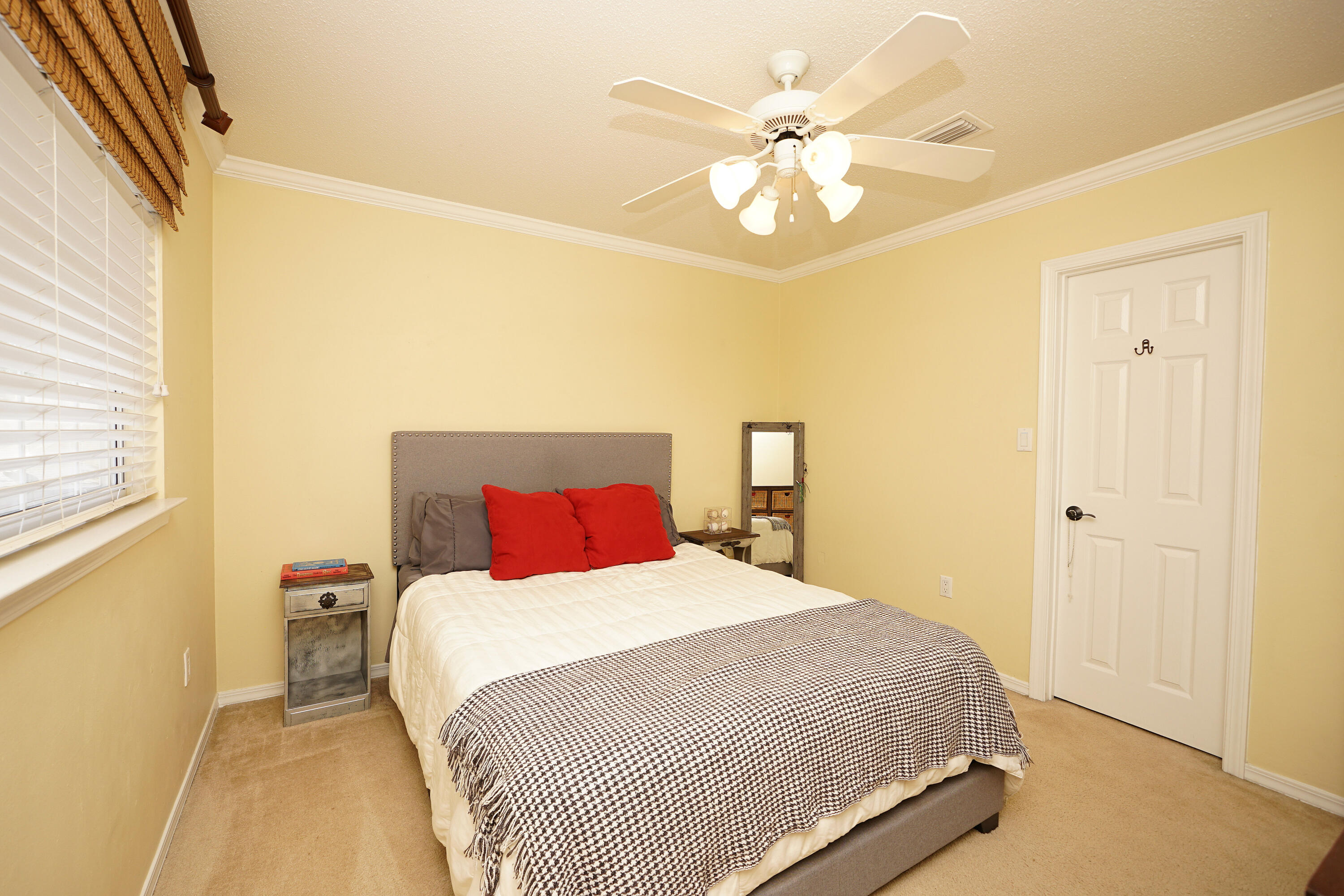 941 Ruckel Drive Niceville, FL 32578 - Photo 45 of 57 a bedroom with a bed and a chandelier