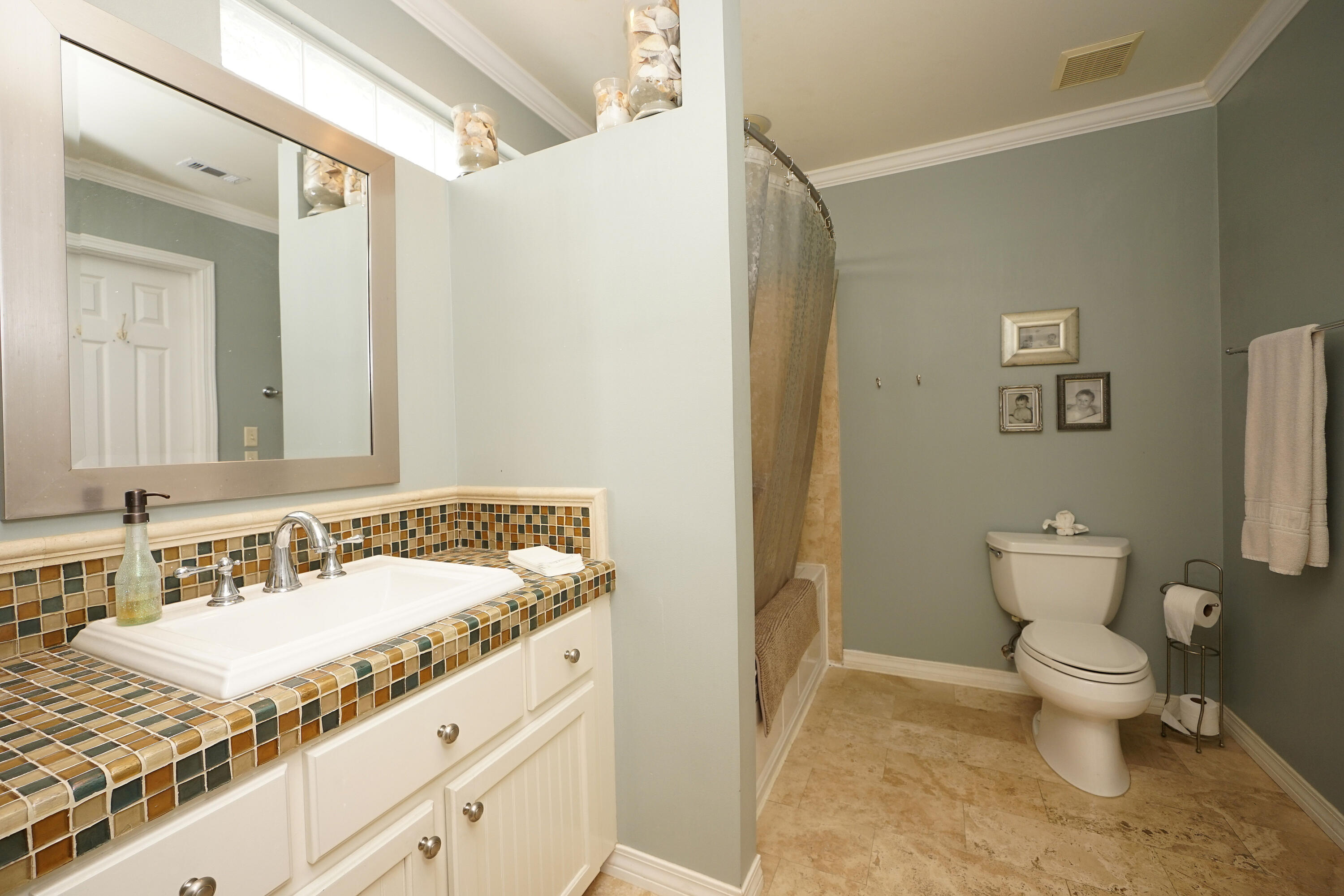 941 Ruckel Drive Niceville, FL 32578 - Photo 46 of 57 a bathroom with a granite countertop sink a toilet and a mirror