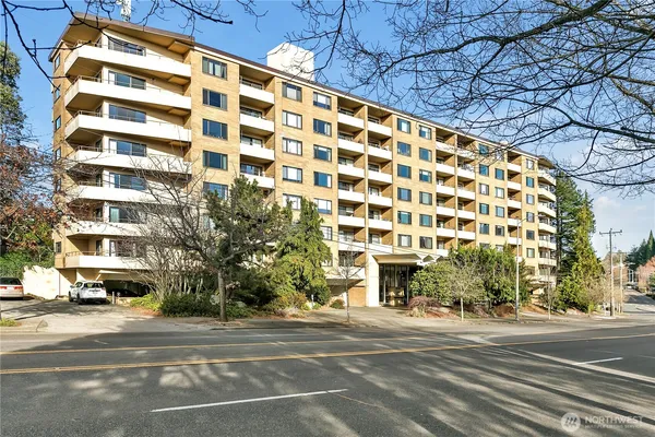 a view of a tall building next to a road