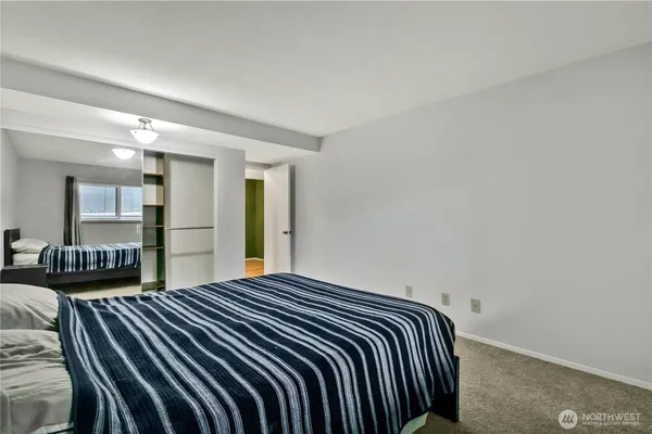 a bedroom with double bed and a night stand
