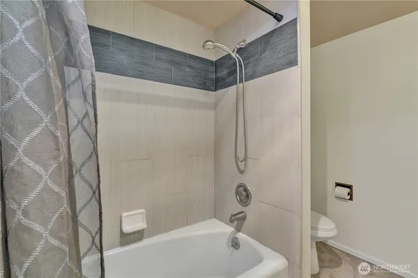 a bathroom with a shower and a toilet