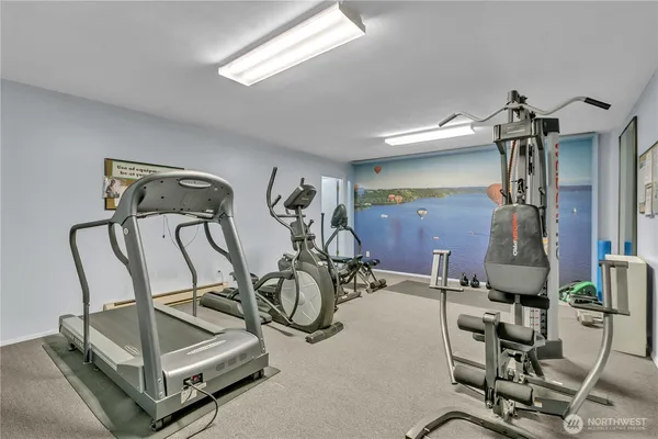 a room with gym equipment and white walls