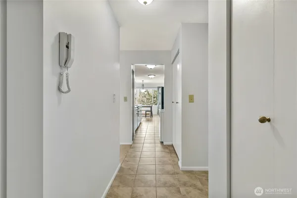 a view of a hallway with wooden floor