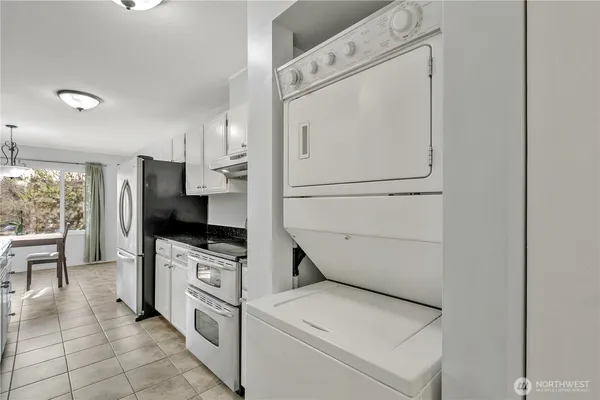 a kitchen with white cabinets and white appliances