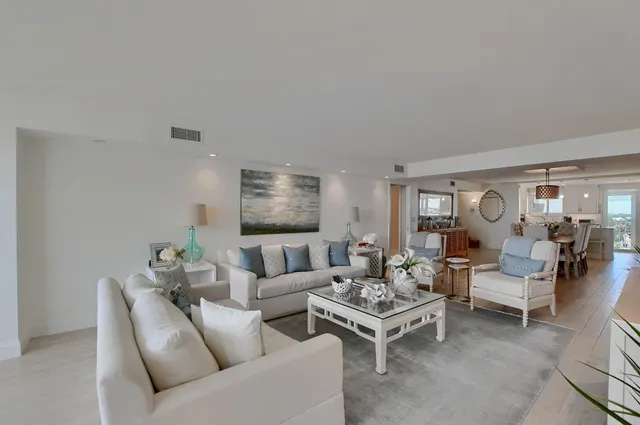 a living room with furniture wooden floor and lamp