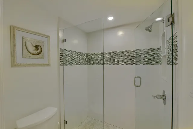 a bathroom with a shower a toilet and a sink