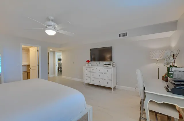 a bedroom with furniture and flat screen tv
