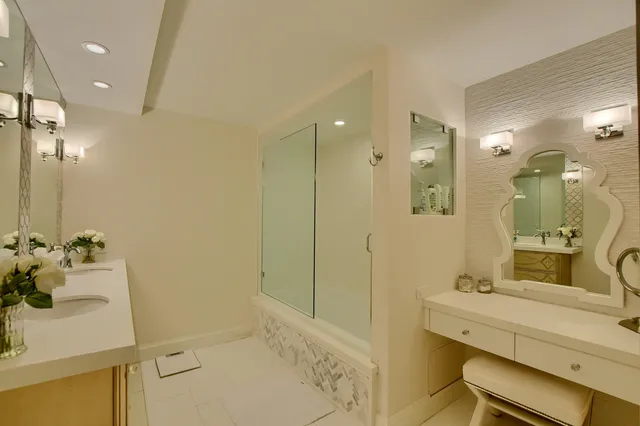 a bathroom with a sink mirror and a shower
